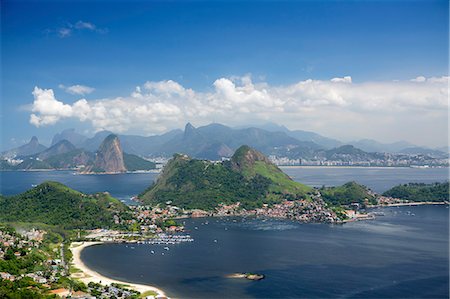 View of Rio, the Serra da Carioca mountains and Sugar Loaf with Charitas and Sao Francisco beaches in Niteroi in the foreground, Rio de Janeiro, Brazil, South America Stock Photo - Rights-Managed, Code: 841-08211509