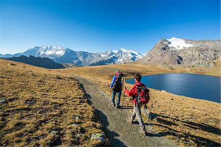 Hikers wallking along Rosset Lake, Gran Paradiso National Park, Alpi Graie (Graian Alps), Italy, Europe Stock Photo - Rights-Managed, Code: 841-08211531