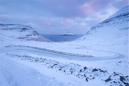 denmark natural beauty faroe - Snow covered road winding down between mountains near Nordradalur on the Island of Streymoy, Faroe Islands, Denmark, Europe Stock Photo - Rights-Managed, Code: 841-08211717