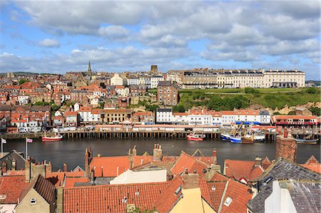 View across rooftops to West Side town, boats, pier, fish market and elegant hotels, Whitby, North Yorkshire, England, United Kingdom, Europe Stock Photo - Rights-Managed, Code: 841-08220819