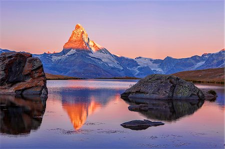 switzerland - Pink sky at sunrise on the Matterhorn reflected in Stellisee, Zermatt, Canton of Valais, Pennine Alps, Swiss Alps, Switzerland, Europe Stock Photo - Rights-Managed, Code: 841-08220856