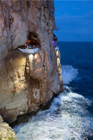 Bar built in cliff caves, Cova d'en Xoroi in evening, Cala en Porter, Menorca, Balearic Islands, Spain, Mediterranean, Europe Foto de stock - Con derechos protegidos, Código: 841-08221038