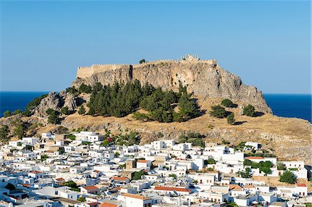 White rooftops of Lindos with the Acropolis of Lindos, Rhodes, Dodecanese, Greek Islands, Greece, Europe Stock Photo - Rights-Managed, Code: 841-08221049