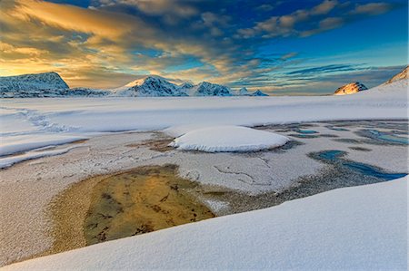 photos ice floats - The golden sunrise reflected in a pool of the clear sea where the snow has melted, Haukland, Lofoten Islands, Arctic, Norway, Scandinavia, Europe Stock Photo - Rights-Managed, Code: 841-08244003