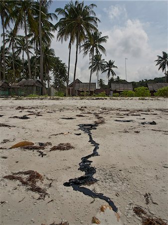 Tar pollution on beach due to oil spillages from shipping in Bintan Island, Sumatra, Indonesia, Southeast Asia, Asia Stock Photo - Rights-Managed, Code: 841-08279142