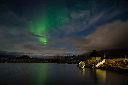 Aurora borealis over lake with boats and Kota, Kilpisjarvi, Northwest Finland, Lapland, Finland, Scandinavia, Europe Stock Photo - Rights-Managed, Code: 841-08279170