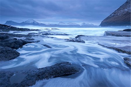 Atlantic waves swirl and crash over the rocky shores of Gjogv on the island of Eysturoy in winter, Faroe Islands, Denmark, Europe Photographie de stock - Rights-Managed, Code: 841-08438764