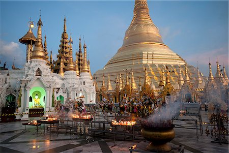 Lit candles placed by devotees at sunset at the Shwesagon Pagoda, a 2500 year old Buddhist pilgrimage site, Yangon, Myanmar (Burma), Asia Stock Photo - Rights-Managed, Code: 841-08438820