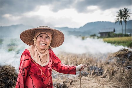 smiling rural indian women - Portrait of a farmer burning crops in rice paddy fields, Bukittinggi, West Sumatra, Indonesia, Southeast Asia, Asia Stock Photo - Rights-Managed, Code: 841-08568817