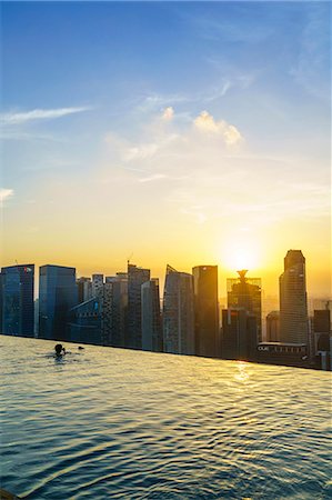 simsearch:841-09242341,k - Infinity pool on the roof of the Marina Bay Sands Hotel with spectacular views over the Singapore skyline at sunset, Singapore, Southeast Asia, Asia Stock Photo - Rights-Managed, Code: 841-08729592