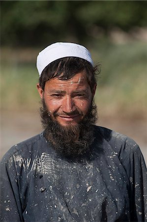 Afghani farmer from Herat Province takes a break from working in rice paddies to smile for the camera, Afghanistan, Asia Stock Photo - Rights-Managed, Code: 841-08781771