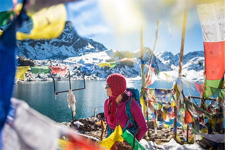 A trekker stands among prayer flags beside the holy lakes at Gosainkund in the Langtang region, Himalayas, Nepal, Asia Photographie de stock - Rights-Managed, Code: 841-08797810