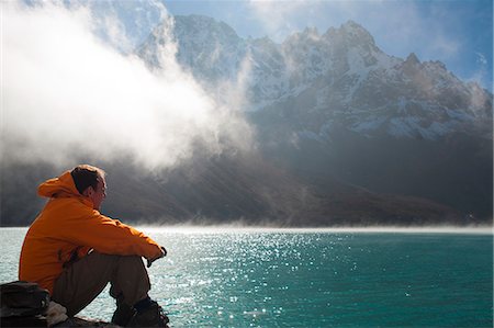 A trekker in the Everest region looks out over Gokyo Lake, Khumbu Region, Nepal, Asia Stock Photo - Rights-Managed, Code: 841-08797850