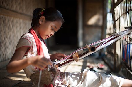 A little girl learns the skill of weaving on a handloom, Chittagong Hill Tracts, Bangladesh, Asia Stock Photo - Rights-Managed, Code: 841-08797906