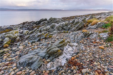 rock formation in scotland - Rocky shore near Pirnmill looking out across the Kilbrannan Sound to Mull of Kintyre, Isle of Arran, North Ayrshire, Scotland, United Kingdom, Europe Stock Photo - Rights-Managed, Code: 841-08821794