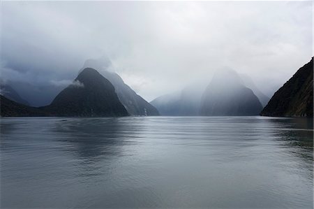 dreamy and nobody - View down rainswept Milford Sound, mountains obscured by cloud, Milford Sound, Fiordland National Park, UNESCO World Heritage Site, Southland, South Island, New Zealand, Pacific Stock Photo - Rights-Managed, Code: 841-08861006