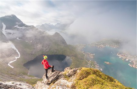 simsearch:841-03676712,k - Hiker on summit admires the blue lake and sea framing the village, Reinebringen, Moskenesoya, Lofoten Islands, Norway, Scandinavia, Europe Stock Photo - Rights-Managed, Code: 841-08887172