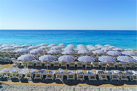 french riviera travel - Blue and white beach parasols, Nice, Alpes-Maritimes, Cote d'Azur, Provence, French Riviera, France, Mediterranean, Europe Stock Photo - Rights-Managed, Code: 841-08887320