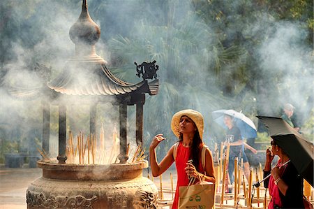 smoking women - Burning incense at Po Lin Monastery, Ngong Ping, Lantau Island, Hong Kong, China, Asia Stock Photo - Rights-Managed, Code: 841-09055403