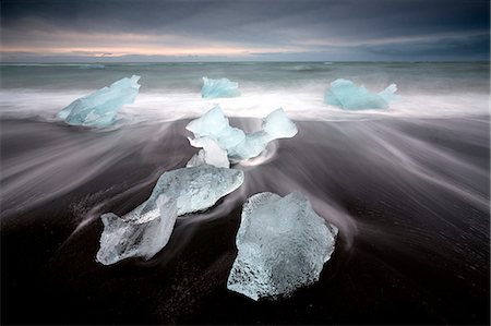 simsearch:841-08220894,k - Glassy pieces of ice on volcanic black sand beach with blurred waves, near Jokulsarlon Lagoon, South Iceland, Polar Regions Stock Photo - Rights-Managed, Code: 841-09076975