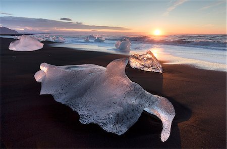 simsearch:6119-09170077,k - Glassy pieces of ice on volcanic black sand beach at sunrise, near Jokulsarlon Lagoon, South Iceland, Polar Regions Stock Photo - Rights-Managed, Code: 841-09076979