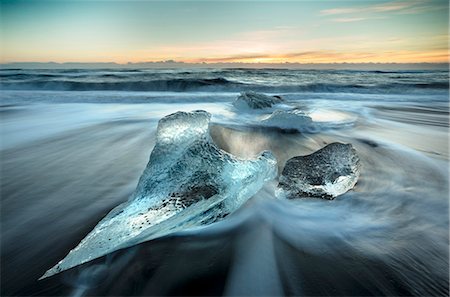 simsearch:6119-08062162,k - Pieces of glacier ice washed up on black volcanic sand beach at sunrise, near Jokulsarlon Glacial Lagoon, South Iceland, Polar Regions Stock Photo - Rights-Managed, Code: 841-09077000