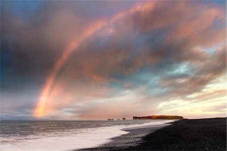 rainbow landscape not person - Distant view of Dyrholaey at sunrise with rainbow, from Halsanefs Hellir Beach near Vik, South Iceland, Polar Regions Stock Photo - Rights-Managed, Code: 841-09077029