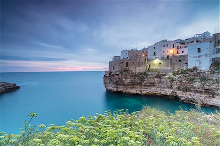 europe town flower - Turquoise sea at sunrise framed by the old town perched on the rocks, Polignano a Mare, Province of Bari, Apulia, Italy, Europe Stock Photo - Rights-Managed, Code: 841-09085864