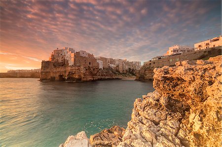 province of bari - Pink sunrise on the turquoise sea framed by old town perched on the rocks, Polignano a Mare, Province of Bari, Apulia, Italy, Europe Stock Photo - Rights-Managed, Code: 841-09085866