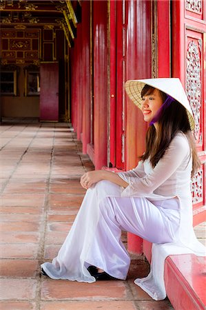 A woman in a traditional Ao Dai dress and Non La conical hat in the Forbidden Purple City of Hue, UNESCO World Heritage Site, Thua Thien Hue, Vietnam, Indochina, Southeast Asia, Asia Stock Photo - Rights-Managed, Code: 841-09108105