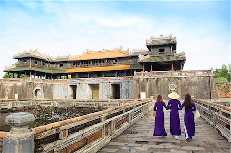 Women in traditional Ao Dai dresses with a paper parasol in the Forbidden Purple City of Hue, UNESCO World Heritage Site, Thua Thien Hue, Vietnam, Indochina, Southeast Asia, Asia Stock Photo - Rights-Managed, Code: 841-09108106