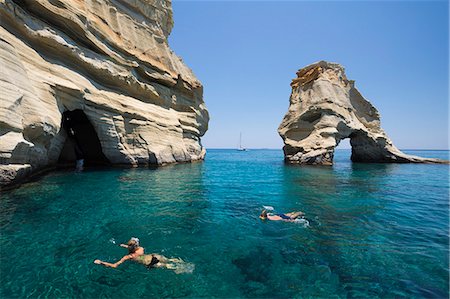 Snorkellers amongst rock formations with crystal clear water, Kleftiko, Milos, Cyclades, Aegean Sea, Greek Islands, Greece, Europe Stock Photo - Rights-Managed, Code: 841-09163500