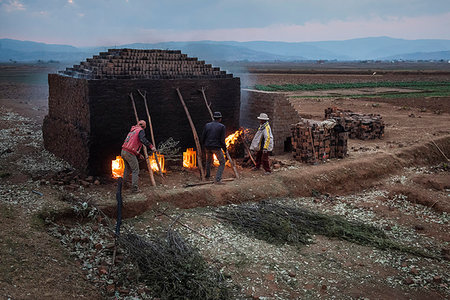 Brick workers firing a kiln near Antsirabe, Vakinankaratra Region, Madagascar, Africa Stock Photo - Rights-Managed, Code: 841-09241937