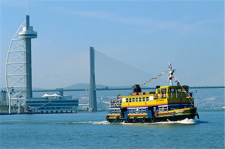 Ferry on the Tejo River near the Expo 98 Park, with the Vasco da Gama Tower and the Vasco da Gama Bridge behind, in Lisbon, Portugal, Europe Stock Photo - Rights-Managed, Code: 841-02704036