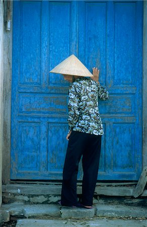 Elderly women wearing traditional hat, against door, Hou An, Vietnam, Indochina, Southeast Asia, Asia Stock Photo - Rights-Managed, Code: 841-02704417