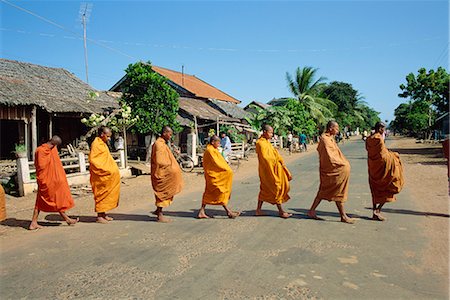 simsearch:841-06805719,k - Monks with begging bowls beneath saffron robes go out in the morning in Cambodia, Indochina, Southeast Asia, Asia Stock Photo - Rights-Managed, Code: 841-02704441