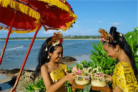 Two women prepare an offering to the sea at Jimbaran Beach on the island of Bali, Indonesia, Southeast Asia, Asia Foto de stock - Con derechos protegidos, Código: 841-02705299