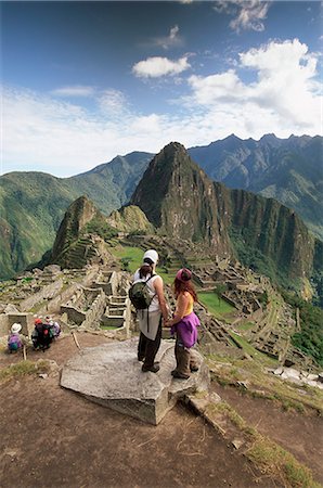 Tourists looking out over the ruins of the Inca site, Machu Picchu, UNESCO World Heritage Site, Urubamba Province, Peru, South America Stock Photo - Rights-Managed, Code: 841-02705636