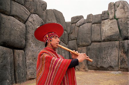 Portrait of a Peruvian man playing a flute, Inca ruins of Sacsayhuaman, near Cuzco, Peru, South America Stock Photo - Rights-Managed, Code: 841-02705661
