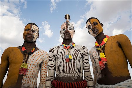 simsearch:841-02916978,k - Three Karo tribesmen with face and body decoration in chalk, imitating the spotted plumage of the guinea fowl, Omo river, Lower Omo Valley, Ethiopia, Africa Stock Photo - Rights-Managed, Code: 841-02705909