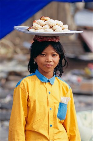 Portrait of a girl carrying buns, Phnom Penh, Cambodia, Indochina, Asia Stock Photo - Rights-Managed, Code: 841-02706137