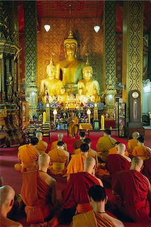 Monks seated inside temple, Wat Phra That Hariphunchai, Lamphun, northern Thailand, Asia Stock Photo - Rights-Managed, Code: 841-02706526