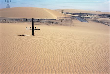 Migrating barchan sand dunes across road marked by buried telegraph poles, Kharga basin, Western Desert, Egypt, North Africa, Africa Stock Photo - Rights-Managed, Code: 841-02706877