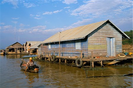single storey - Man in canoe passing a house, floating fishing village of Chong Kneas, Tonle Sap lake, near Siem Reap, Cambodia, Indochina, Southeast Asia, Asia Stock Photo - Rights-Managed, Code: 841-02707282