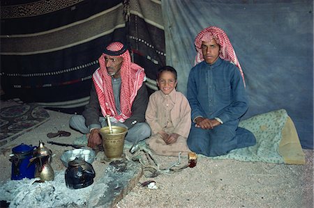 Portrait of three Bedouin sitting inside tent with tea or coffee pots and glasses in Wadi Rum, Jordan, Middle East Stock Photo - Rights-Managed, Code: 841-02707747