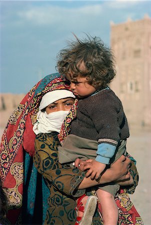 Portrait of a young veiled girl carrying a child, Rawdah, Yemen, Middle East Stock Photo - Rights-Managed, Code: 841-02708544