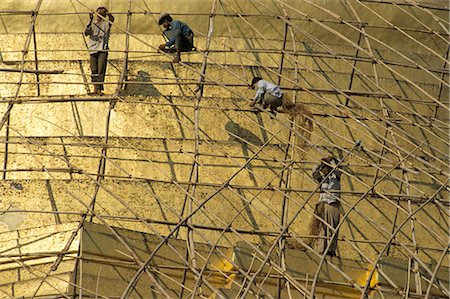 Workers on bamboo scaffolding applying fresh gold leaf to the Shwedagon Pagoda, Yangon (Rangoon), Myanmar (Burma), Asia Stock Photo - Rights-Managed, Code: 841-02709484