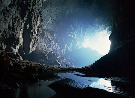 sarawak - Tiny figures show scale of the Deer cave looking back to mouth of the Deer cave, Mulu National Park, Sarawak, island of Borneo, Malaysia, Southeast Asia, Asia Stock Photo - Rights-Managed, Code: 841-02703801