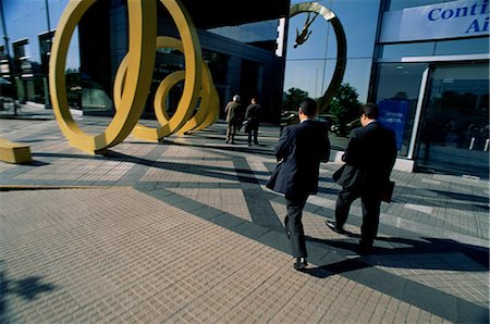 sculptures in the courtyards - Businessmen walking into building with spiral art outside, Santiago, Chile, South America Stock Photo - Rights-Managed, Code: 841-02718596