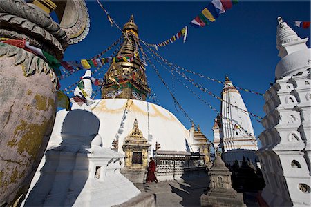 A monk walks clockwise around the buddhist stupa called Swayambhu or Swayambhunath, Kathmandu, Nepal Stock Photo - Rights-Managed, Code: 841-02718674